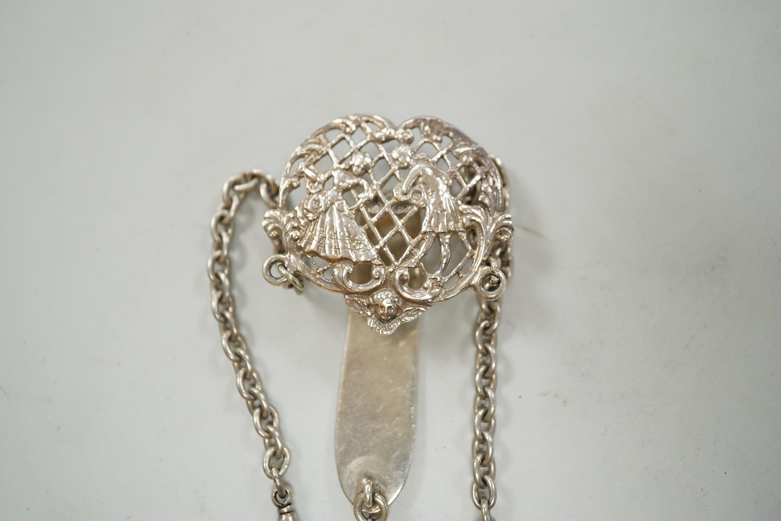 An Edwardian pierced silver chatelaine, by Samuel Jacob, London, 1902, with three accoutrements to include two silver cases and a enamelled fob watch, overall length 34cm.